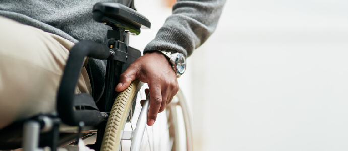 senior man sitting in his wheelchair at home, catastrophic