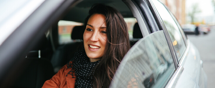 woman driving while smiling