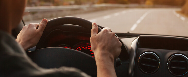 man driving on an empty road