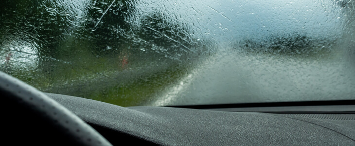 car driving through torrential rain