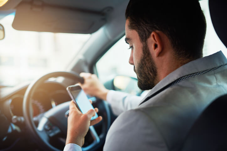 Man texting on phone while driving