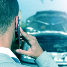 a man making a phone call after being in a car accident