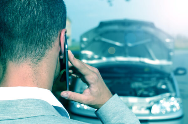 a man making a phone call after being in a car accident