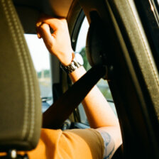 a passenger in a car wearing a seatbelt
