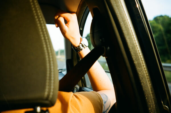 passenger in a car wearing a seatbelt