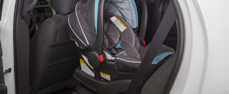 Rear-facing child seat in the back of an SUV car