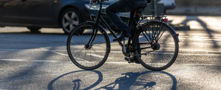 cyclist riding bike on busy street
