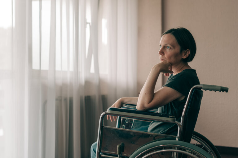 Depressed sad woman in worn wheelchair